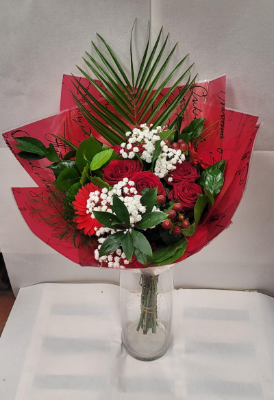 Crimson Romance Bouquet - A striking bouquet highlighted by rich red roses and a vibrant red gerbera daisy, beautifully contrasted with clusters of delicate white filler flowers. Lush green foliage and red berry accents add depth and texture.Wrapped in deep red decorative paper perfect for expressing passion, admiration, or heartfelt celebration.